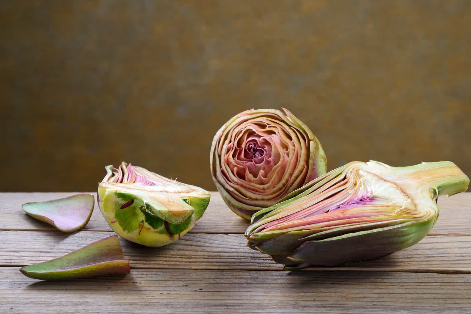 Peeled artichokes on old wooden table