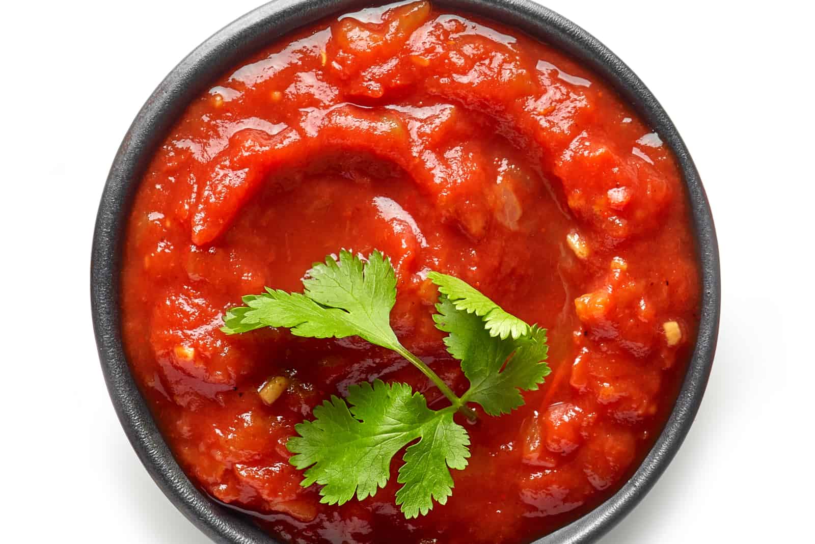 bowl of mexican salsa sauce isolated on white background, top view