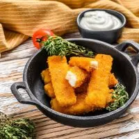 fish sticks on plate with mayo sauce on the side