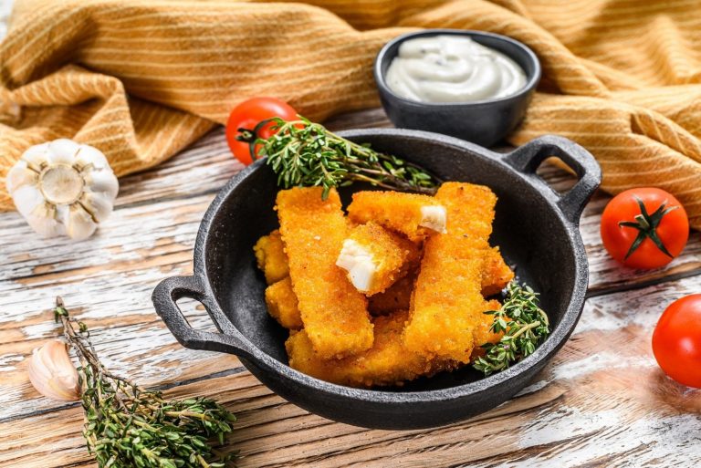 fish sticks on plate with mayo sauce on the side