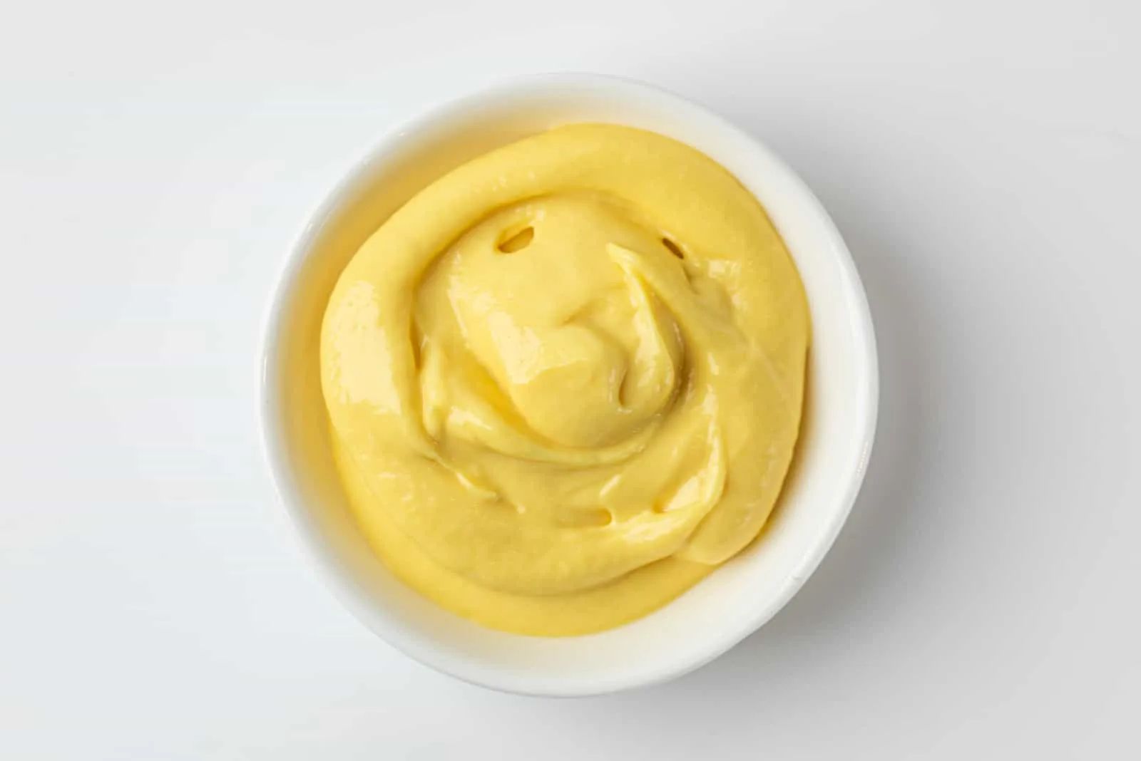 Mustard, sauce in a deep plate, yellow color
