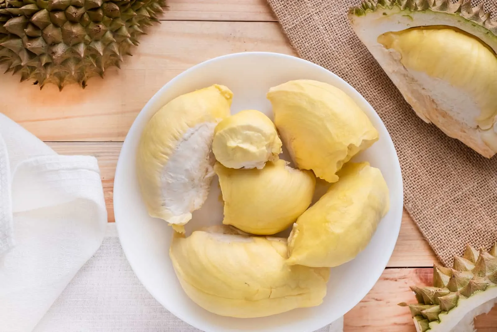 Pieces of fresh ripe durian on wooden table