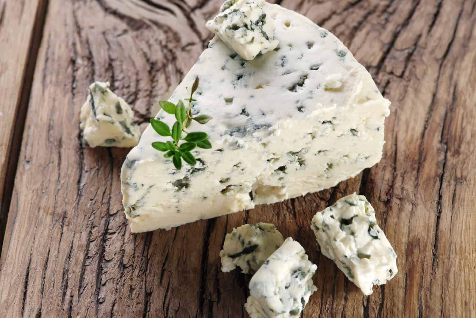 Slices of Blue cheese on an old wooden table