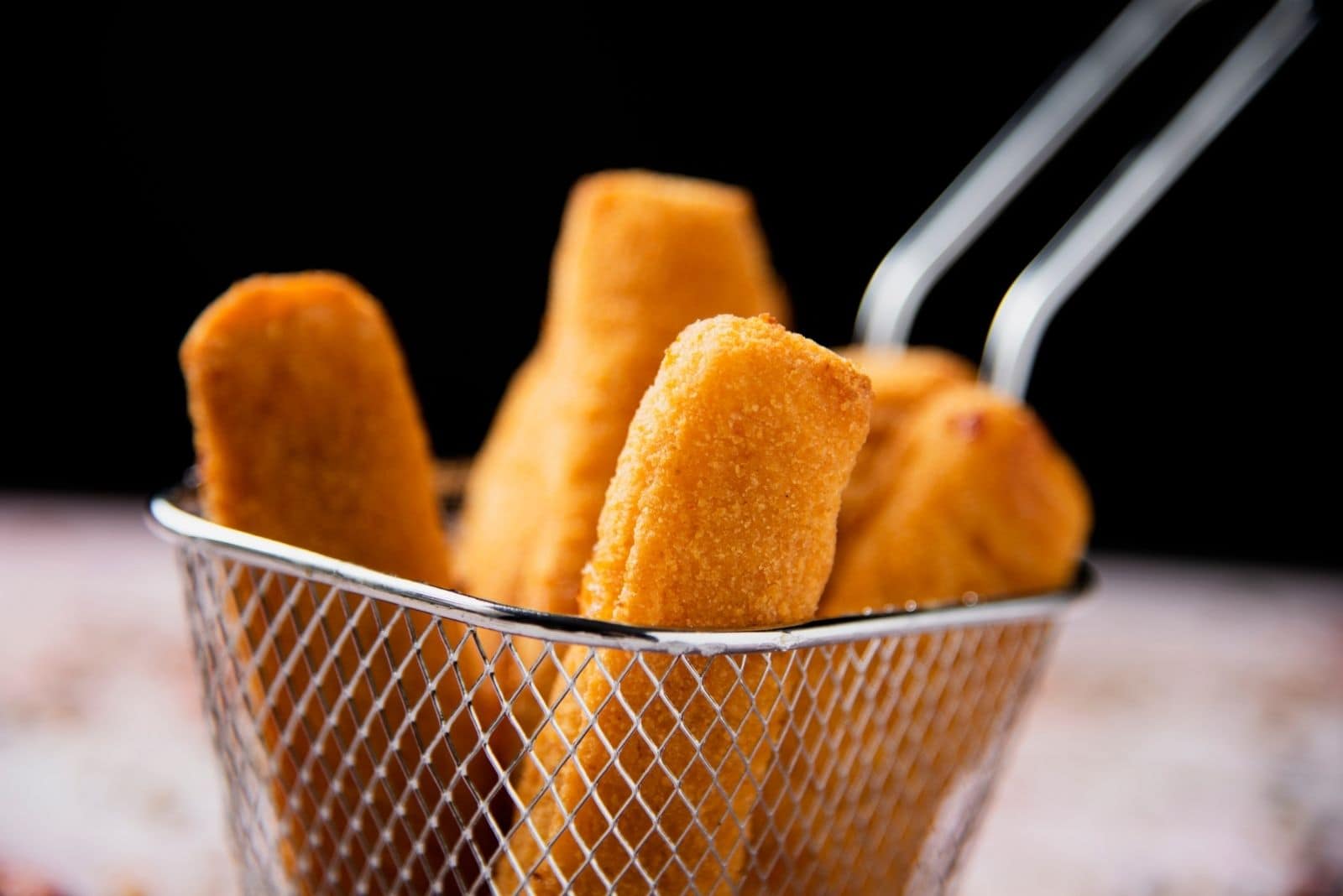 appetizing fish sticks on a strainer