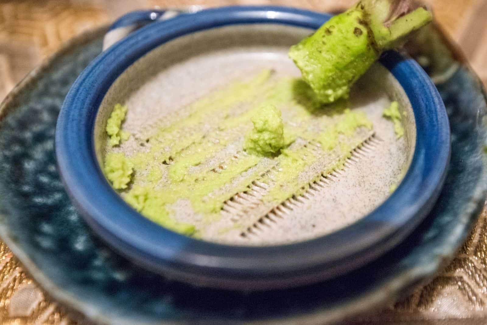 japanese green horseradish grated in a wasabi plate