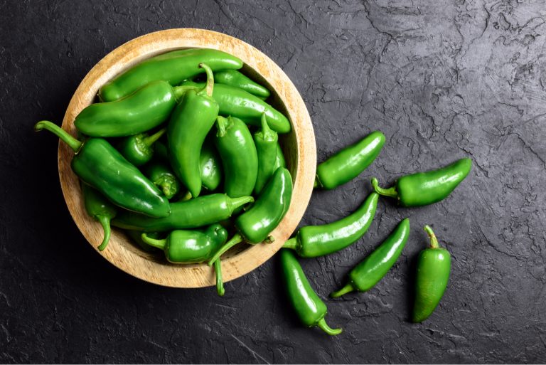 Green jalapeno hot pepper in wooden plate