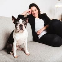 A Woman with is Boston Terrier on the living room