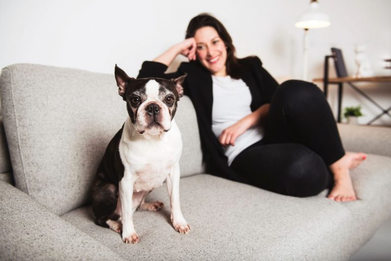 A Woman with is Boston Terrier on the living room