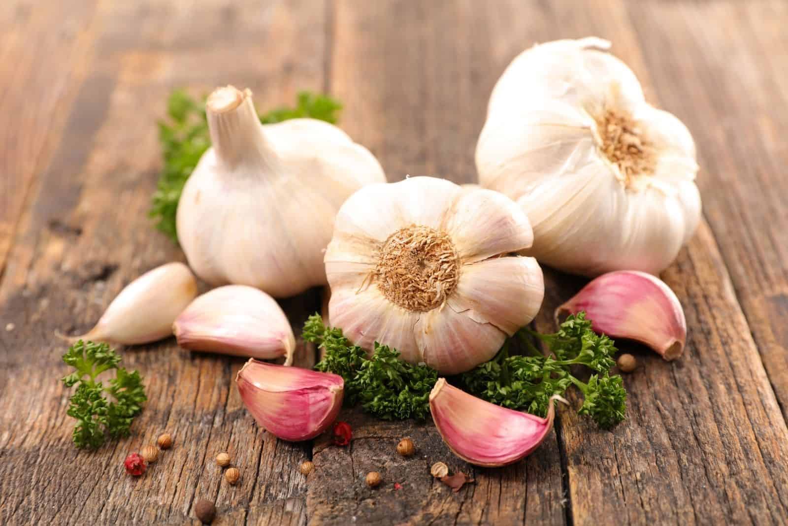 cloves of garlic on a wooden table