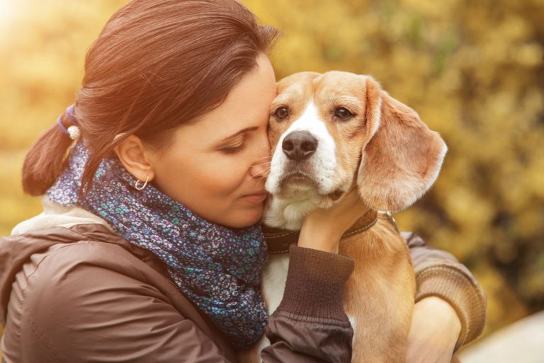 Woman and her favorite dog portrait hugging outdoors