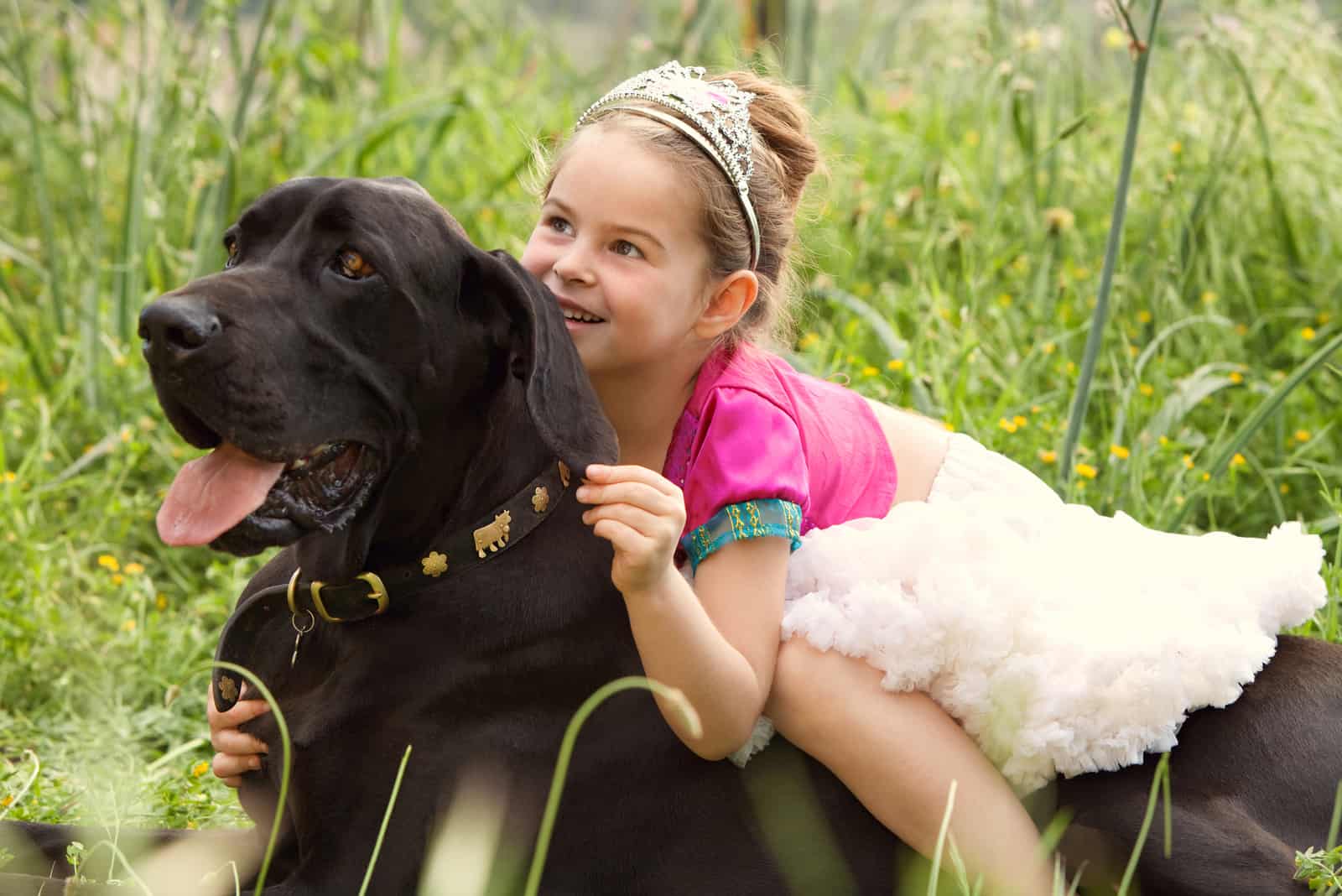 beautiful young girl wearing a fancy dress, sitting on her dog pet back