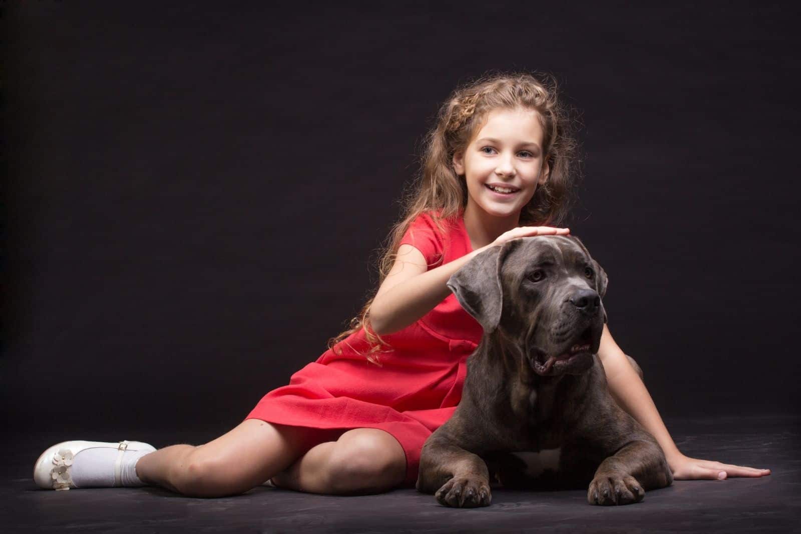 young girl playing with the dog in the studio