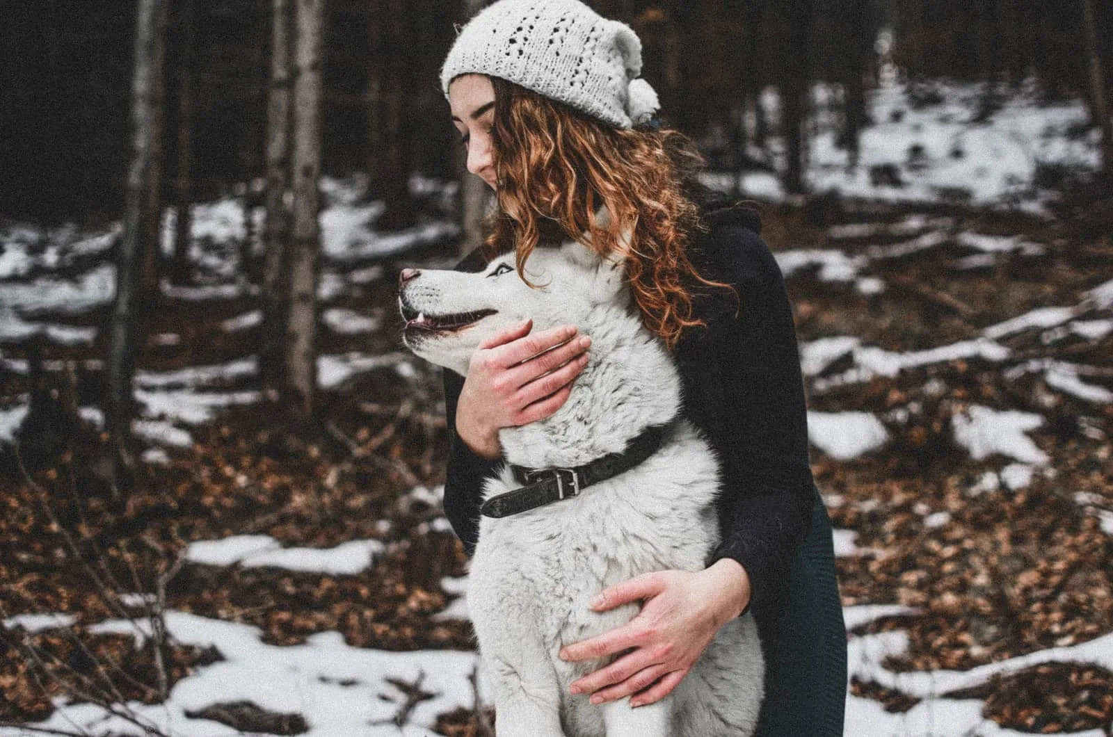 woman hugging her siberian husky dog