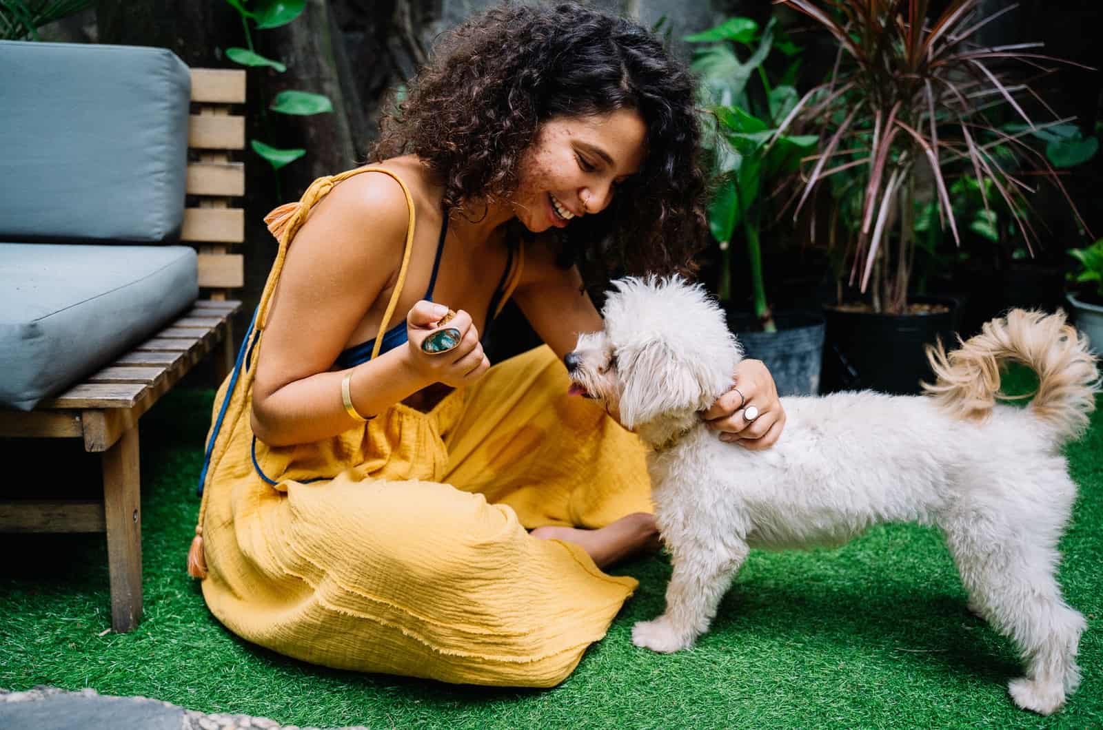 woman in a yellow dress with her dog