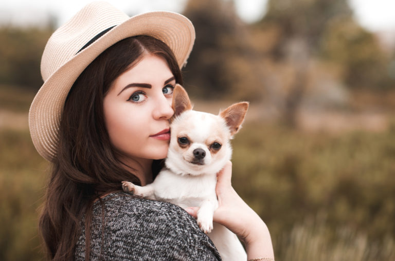 girl posing with her chihuahua pet