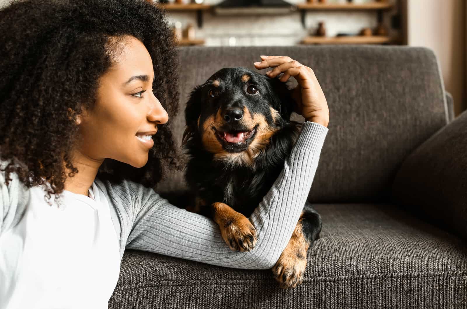 woman hugging dog in house