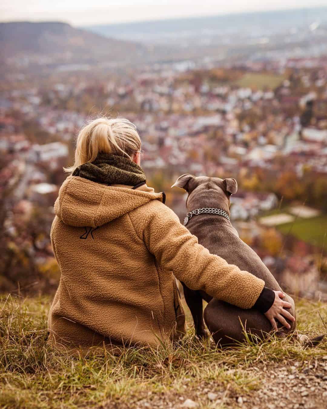 girl and her dog on a hill