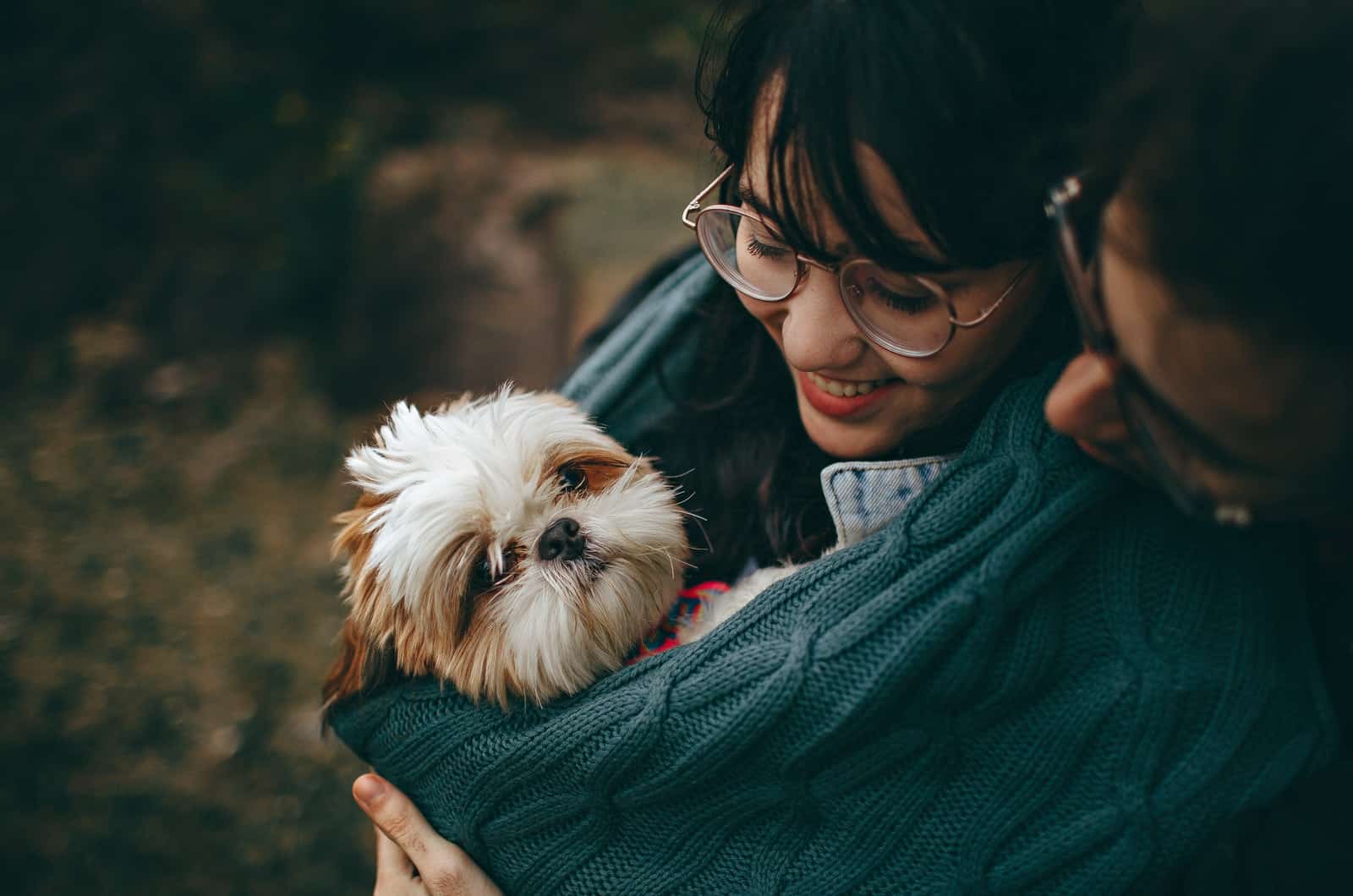 woman holding a small dog