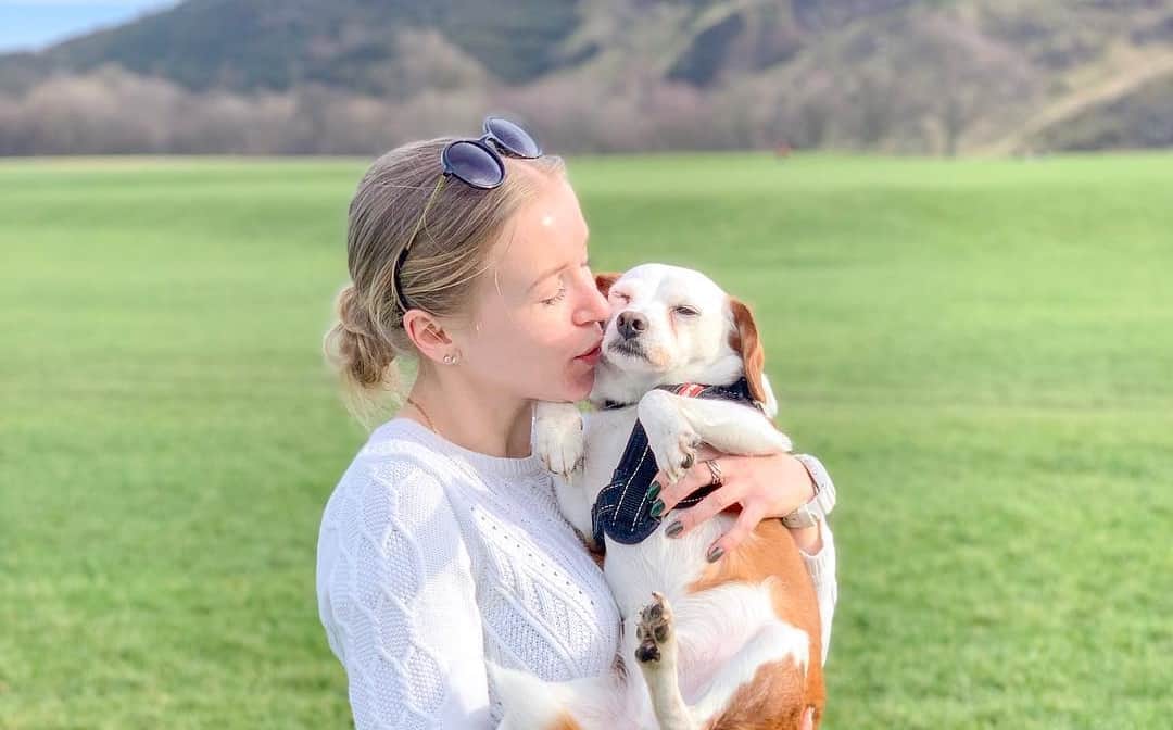 woman hugging dog outside