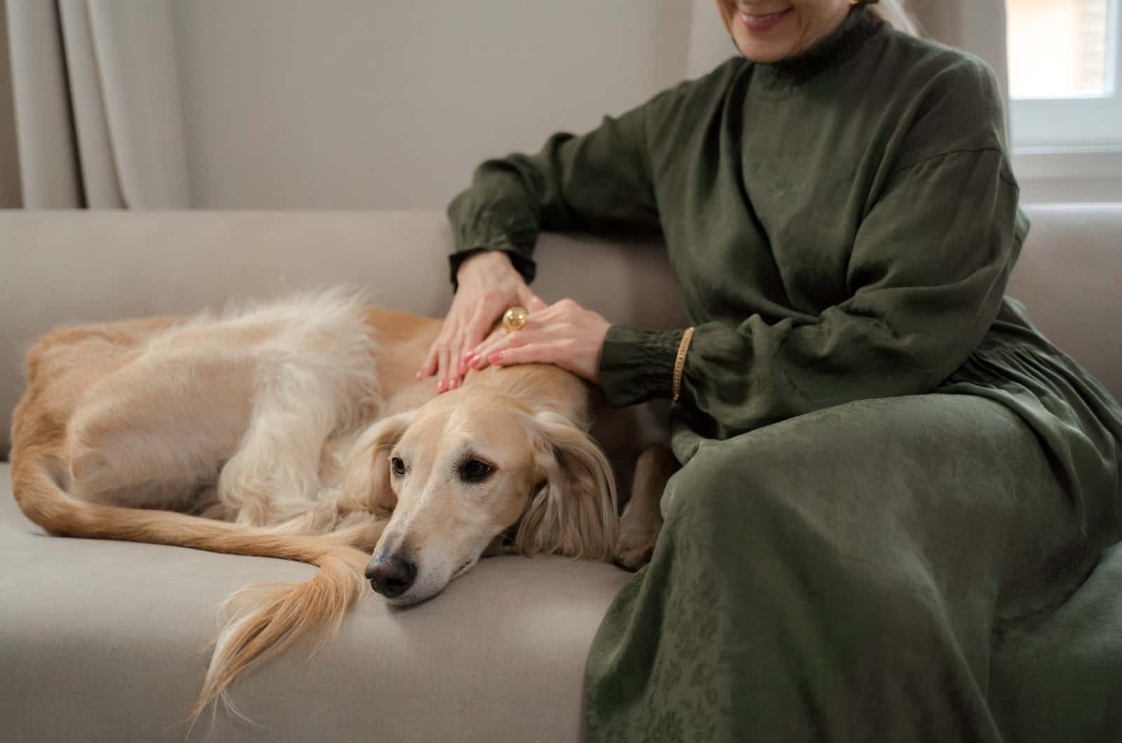 woman sitting beside her dog