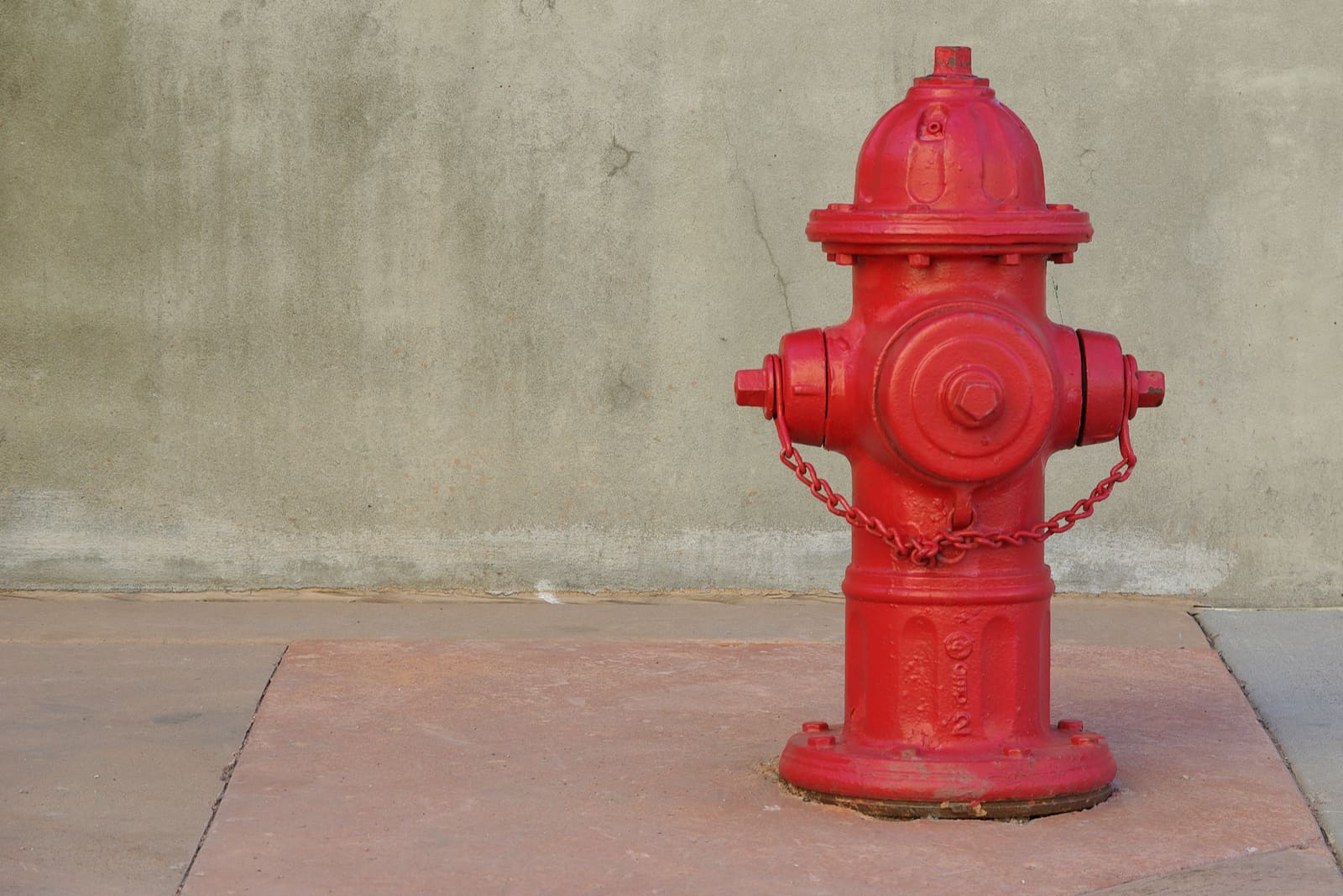 red fire hydrant on a sidewalk