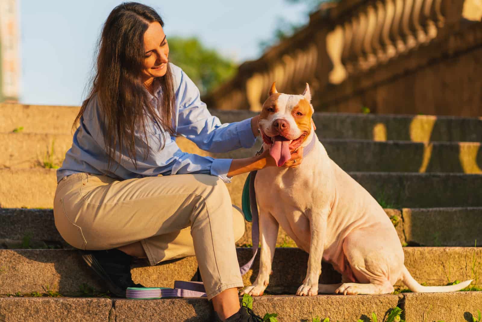 woman posing with her pitbull terrier