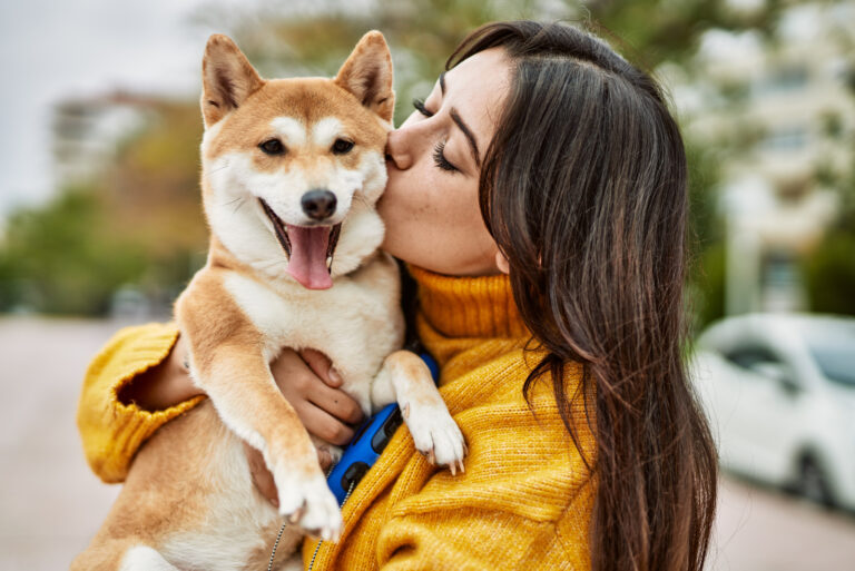 woman kissing her dog