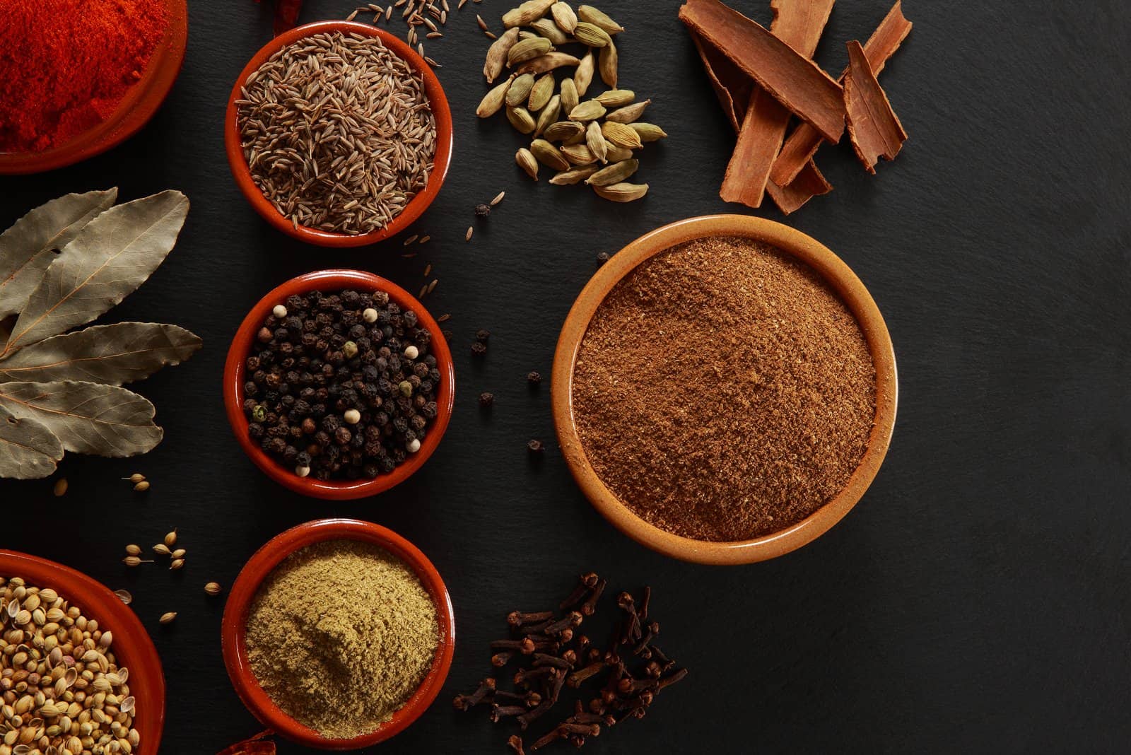 different kind of spices in bowles on the table