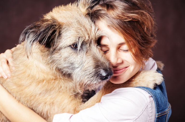 woman hugging a shaggy dog