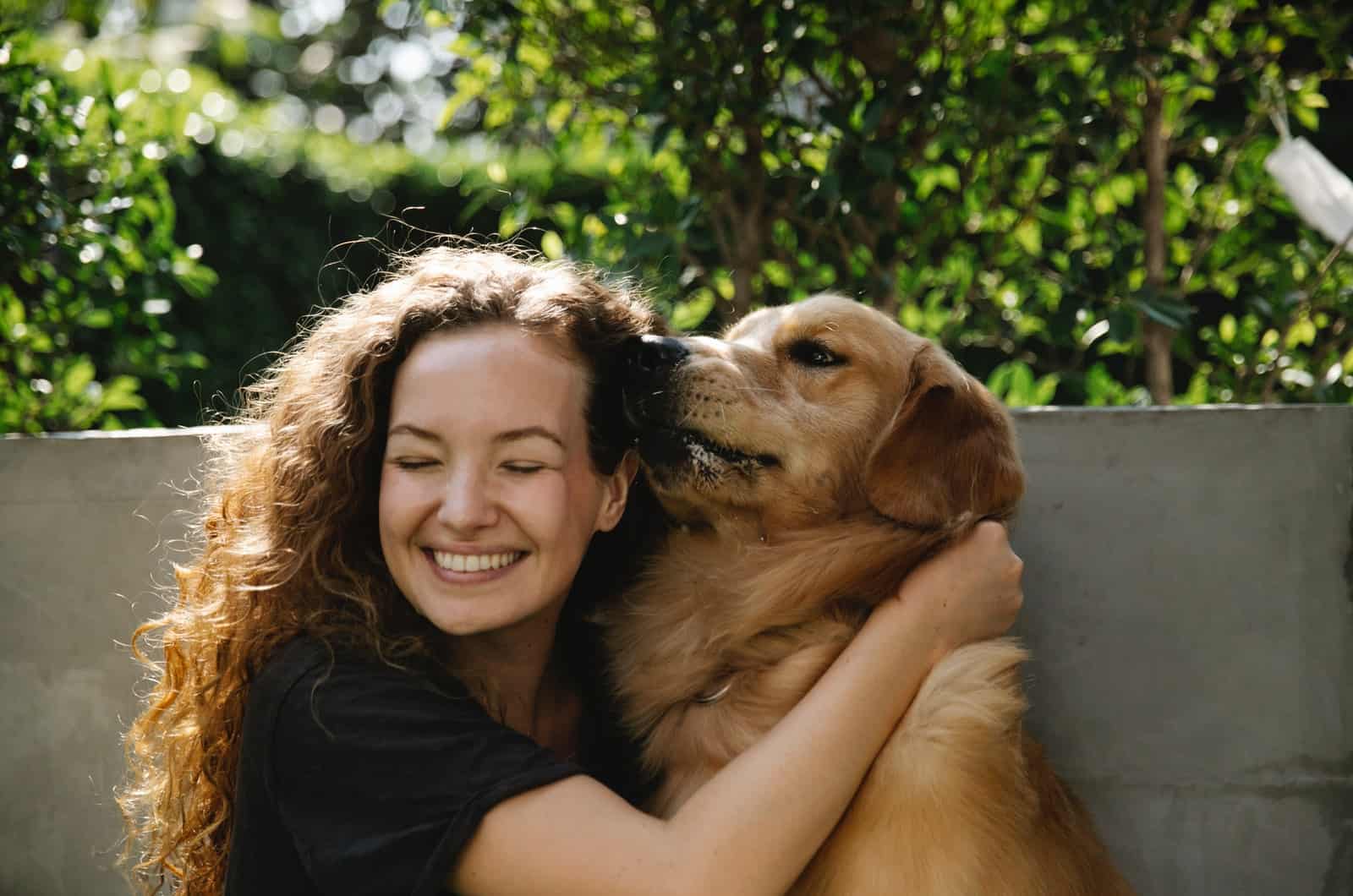 dog licking woman's face