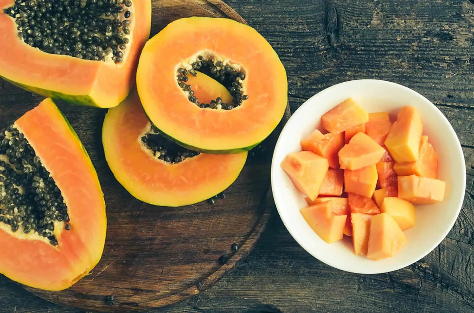 slices of ripe sweet papaya in white bowl