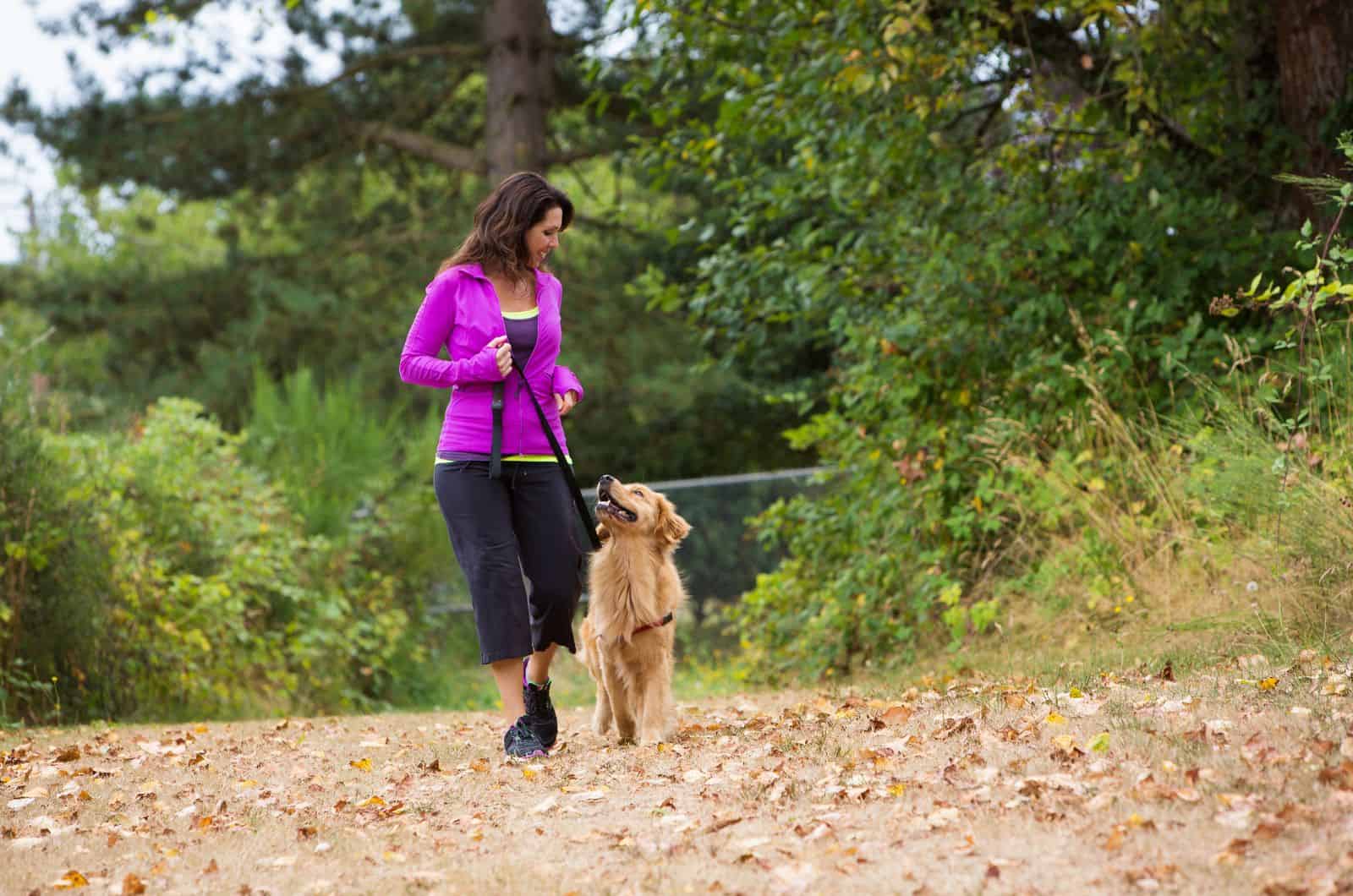 woman walking her dog in nature