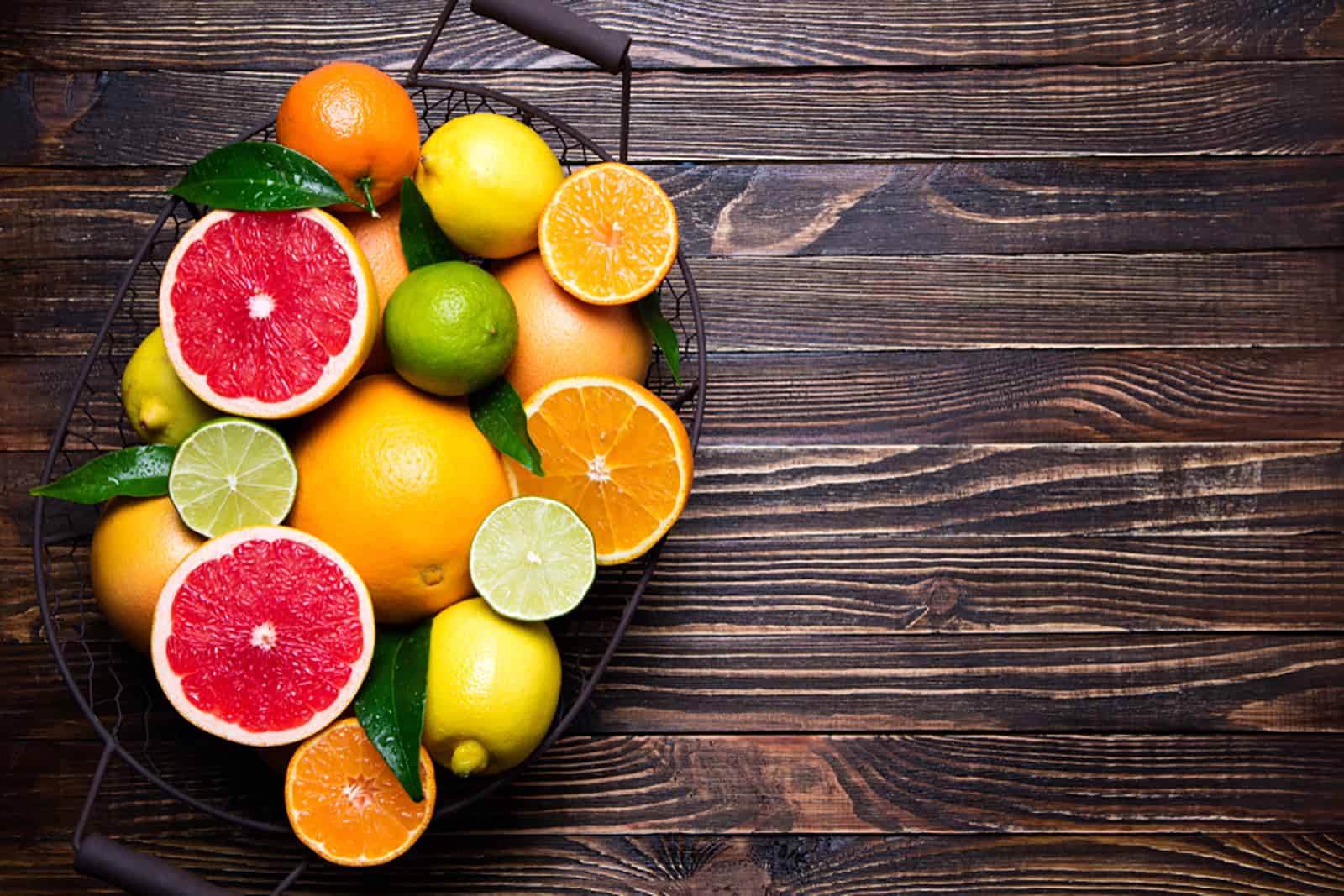 citrus fruits in basket on table