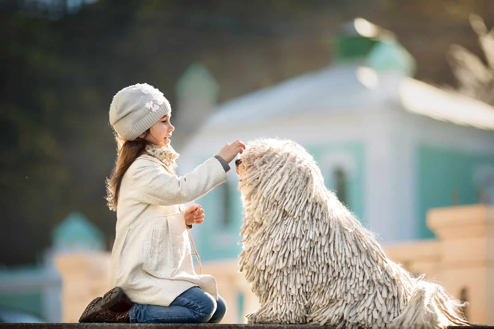 little girl playing with her dog