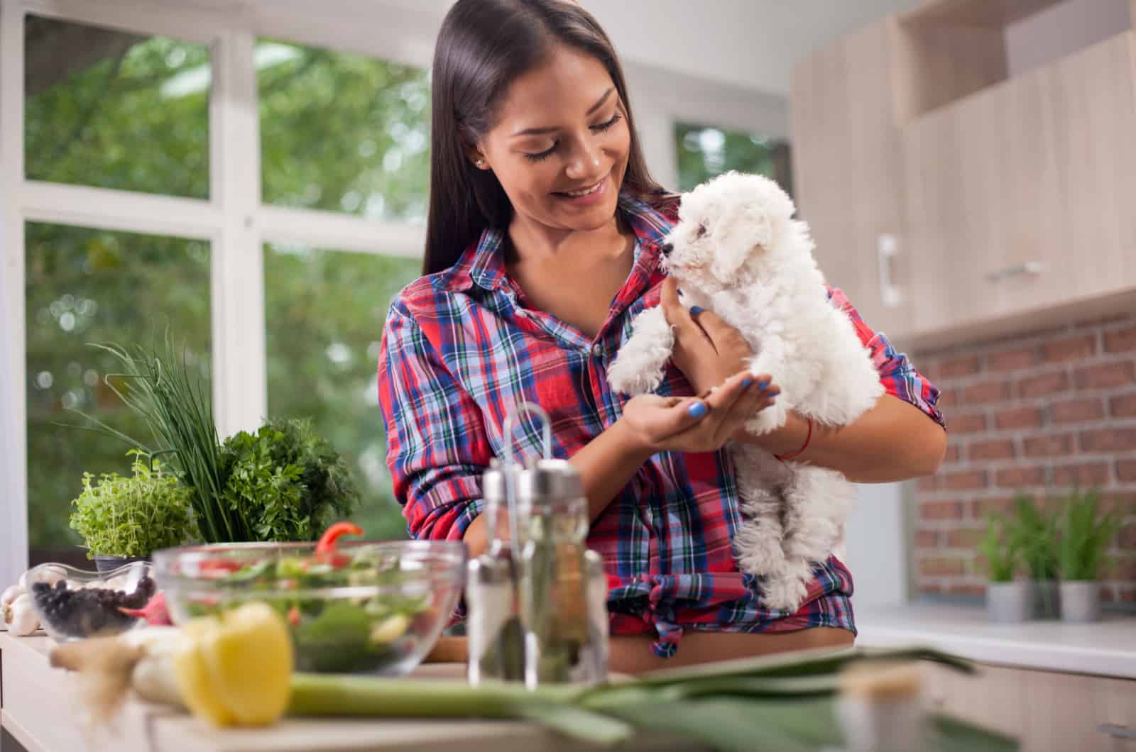 woman in kitchen with dog