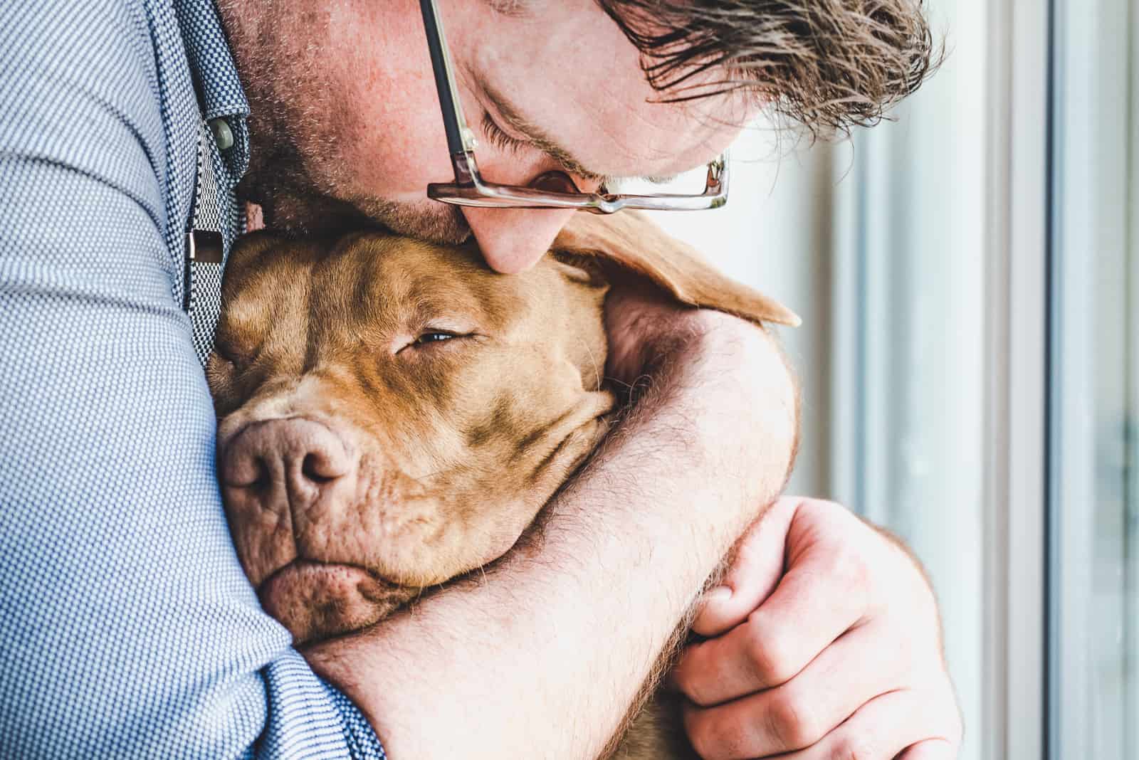 owner smelling his dog