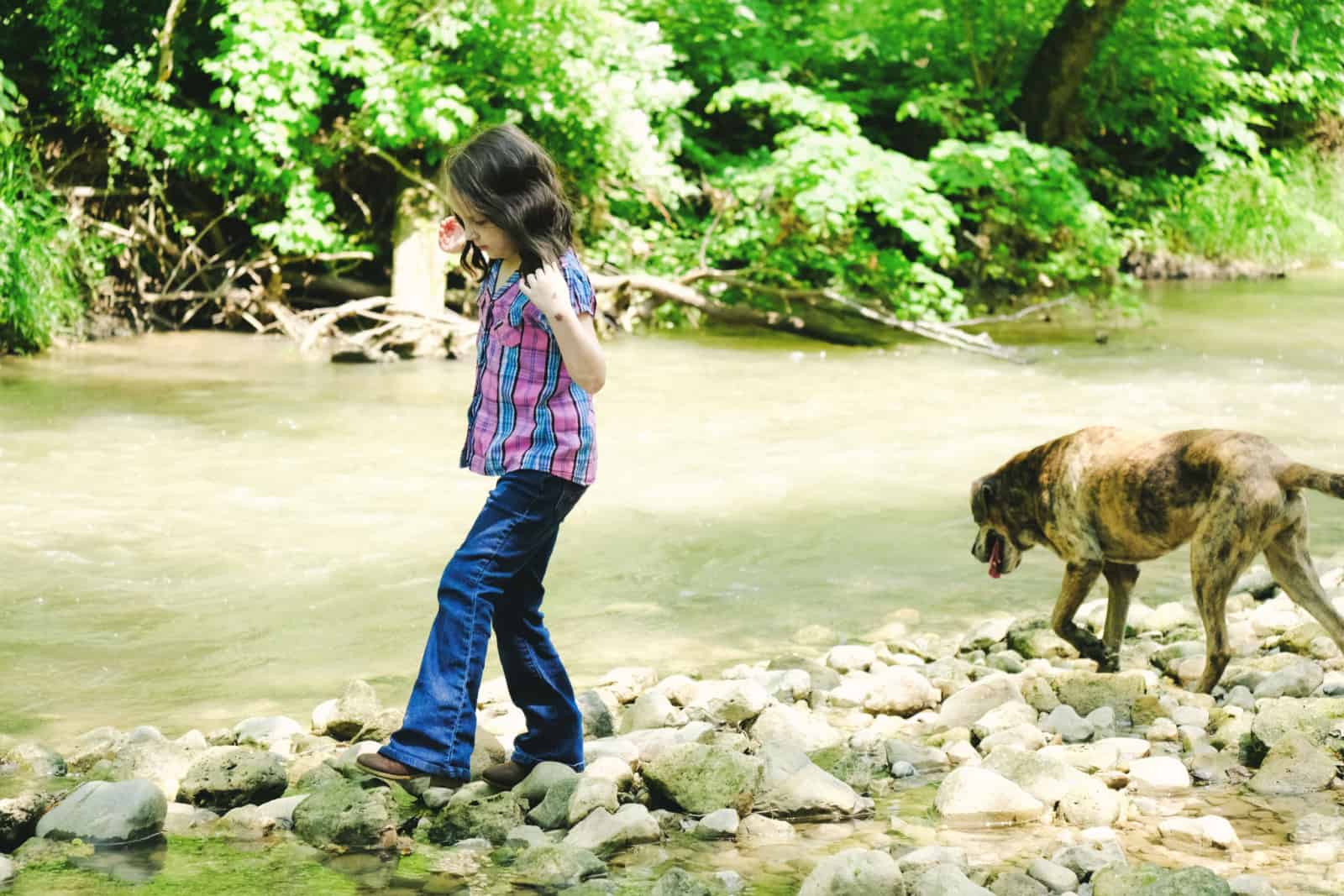 girl walking with catahoula dog