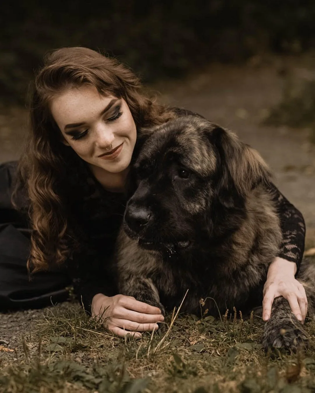 Brindle Anatolian Shepherd in the arms of a woman
