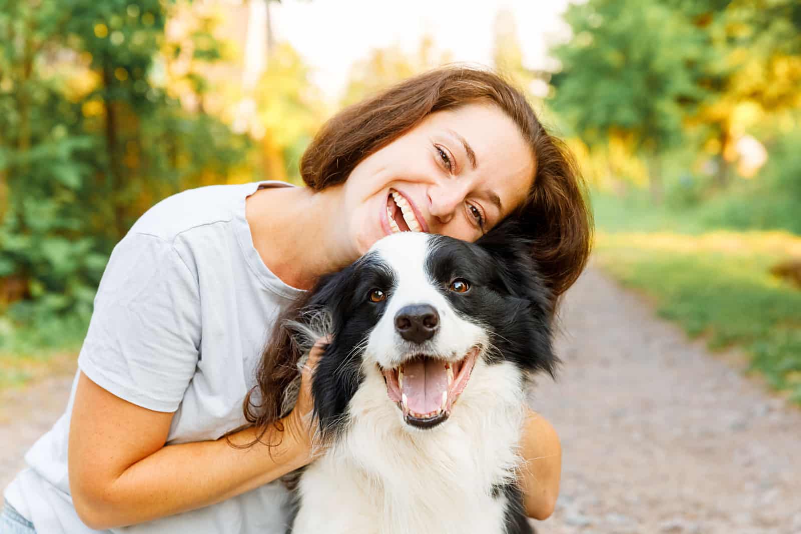 woman hugging her border collie pet