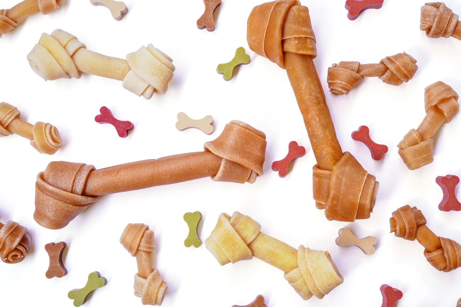 Top view of Dog knotted bone or rawhide and colorful dog snack