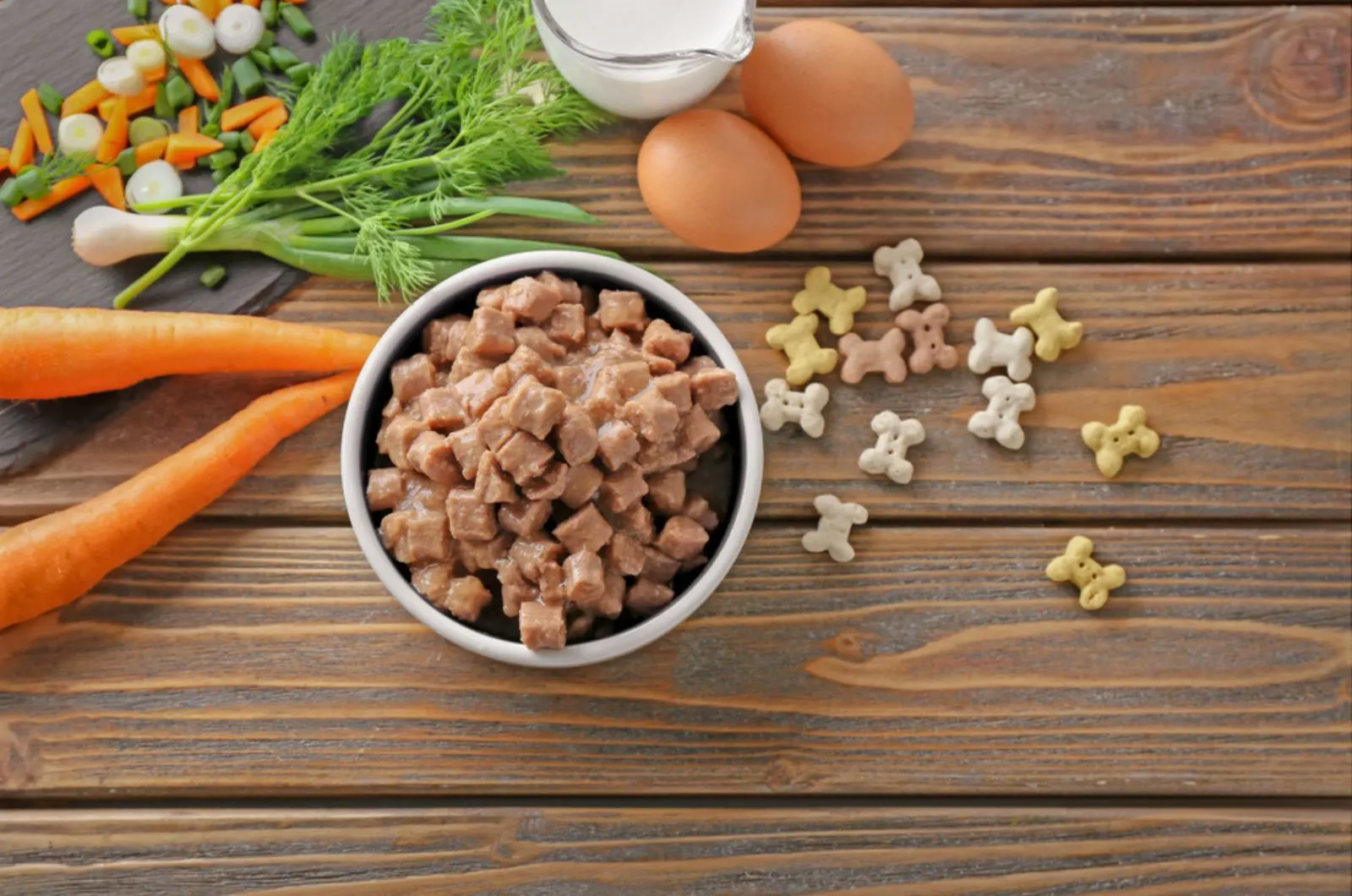 bowl with a pet food and natural product on wooden table