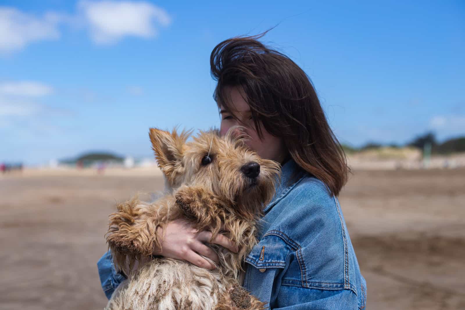 woman holding a scottish terrier