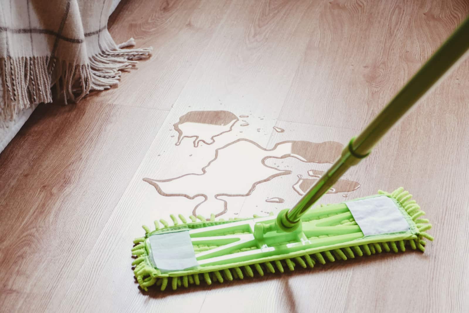 Water on the laminated wooden floor in bedroom