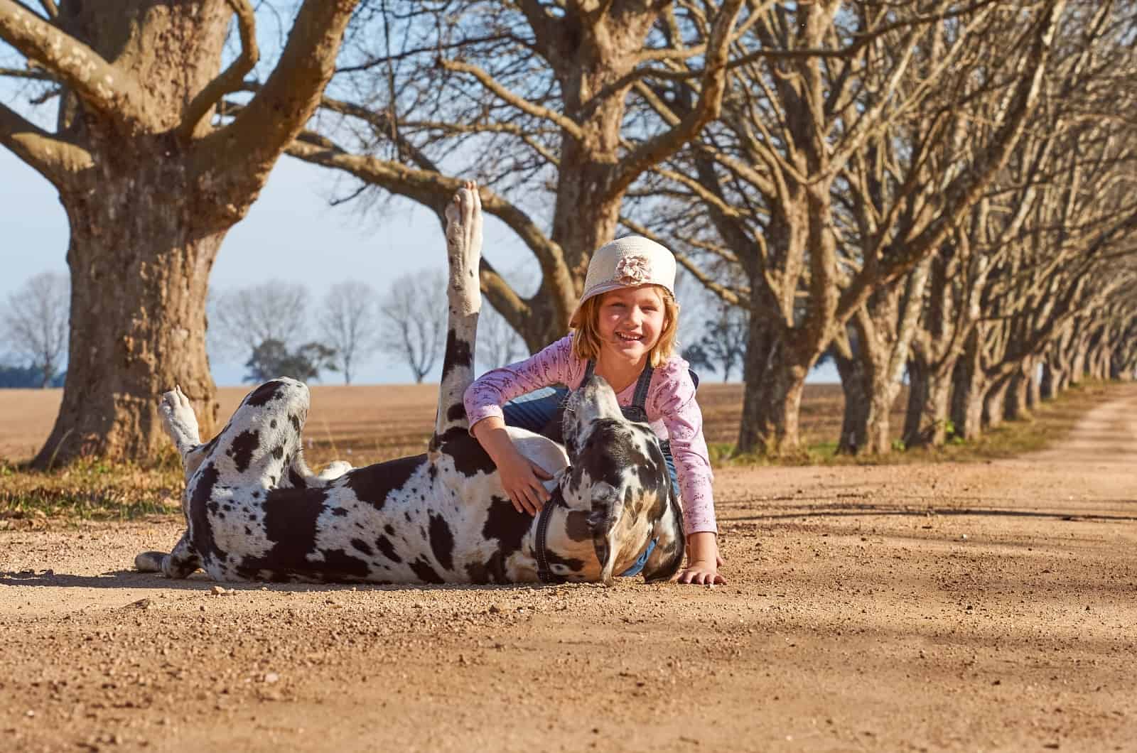 little girl hugging Great Dane