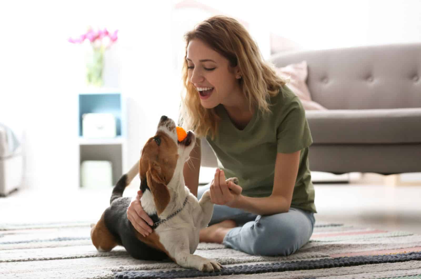 woman playing with her dog at home