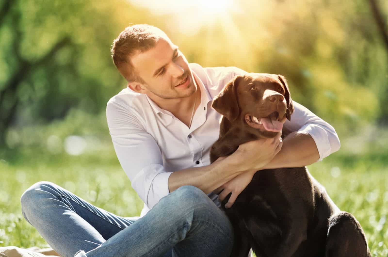 man hugging his dog