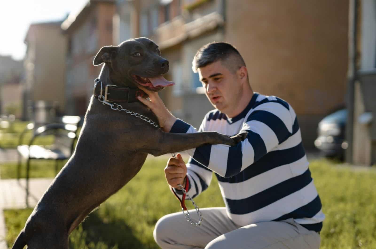 man and his pitbull outdoors