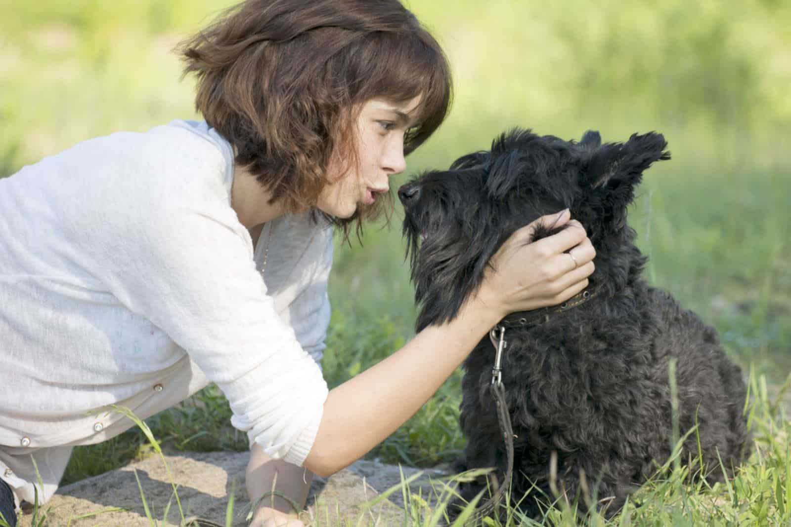 The girl talks to a dog