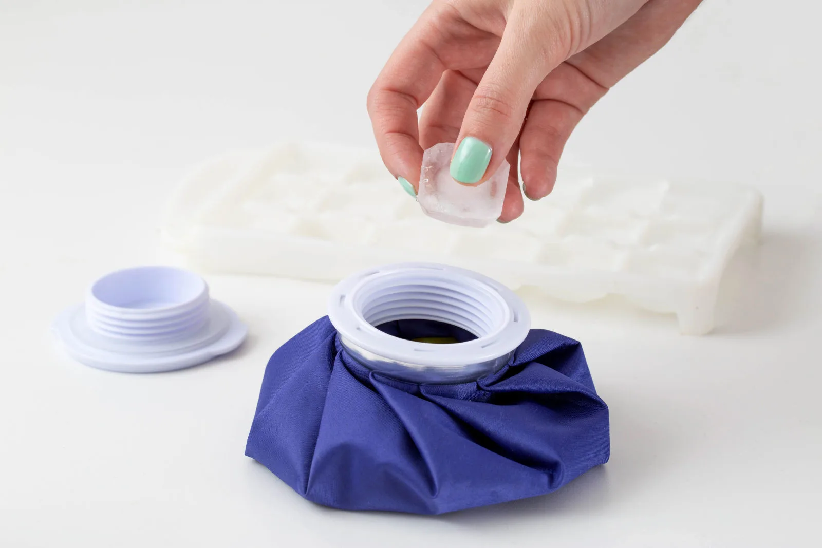 The girl's hand puts a piece of ice into a special medical bag