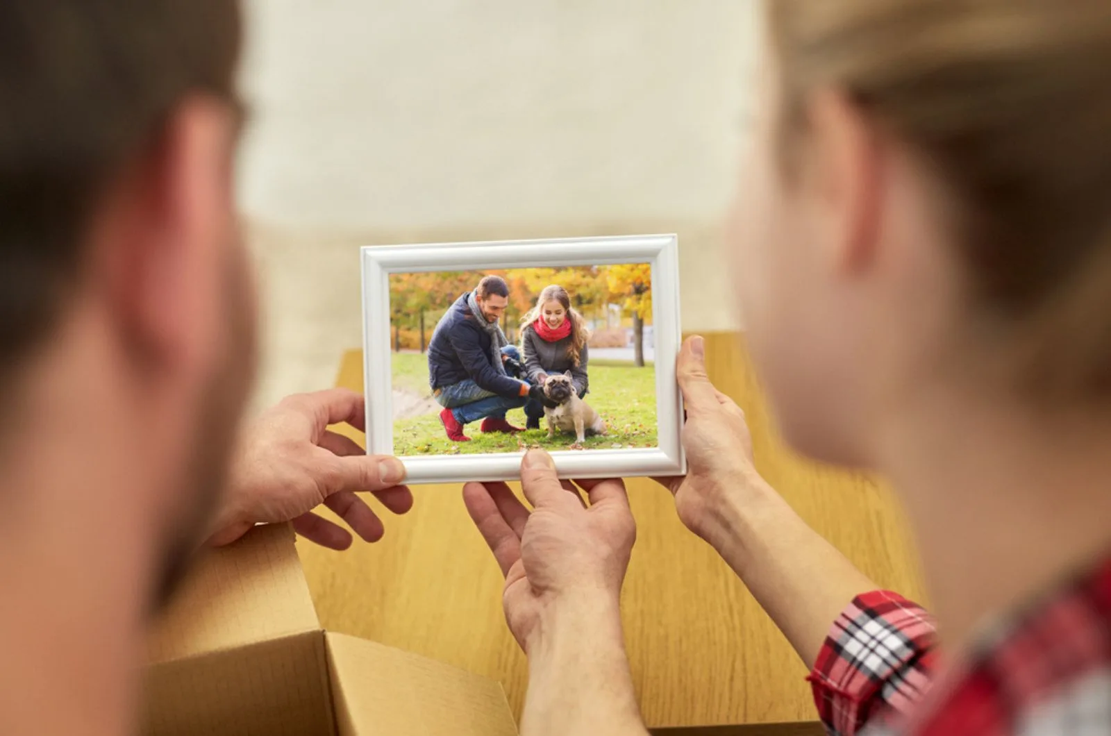 couple looking at photo of their dog
